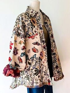 a woman's jacket with butterflies and flowers on it