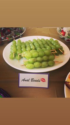 grapes are arranged on skewers and placed on a plate