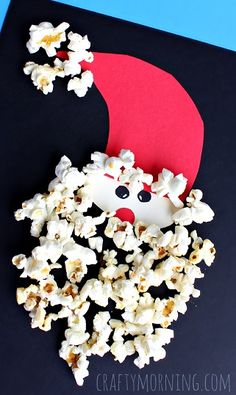 popcorn and santa hat made out of paper on top of a black surface with text overlay