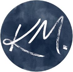 a blue circle with the letter kl on it and an arrow drawn in white ink