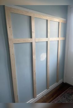 an unfinished room with blue walls and wood framing