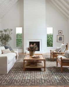 a living room filled with furniture and a fire place in the middle of a room