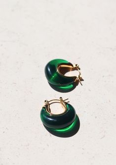 Introducing our enchanting A Thousand Island Earrings - a mesmerising homage to the lush beauty of nature, crafted with the finest deep green emerald. These curve-shaped earrings with mini gold hoops are wearable treasures inspired by the verdant islands, the tranquillity of a hidden paradise, and the timeless allure of nature's wonders. Material: Stainless Steel Waterproof: Yes Hypoallergenic: Suitable for sensitive skin Durability: Non-tarnish Each of our products is beautifully packaged in an elegant, reusable, and recyclable jewellery box, ready for gifting. Green Earrings For May Birthstone, Green Round Earrings For May Birthstone, Modern Green May Birthstone Earrings, Modern Green Earrings For May Birthstone, Elegant Green Hoop Earrings, Modern Green Round Earrings, Green Emerald Hoop Earrings, Modern Green Emerald Jewelry, Green Emerald Round Earrings