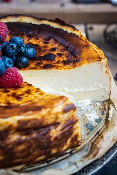 a cheesecake with berries and blueberries on top