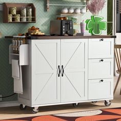 a kitchen cart with some food on top of it in front of a green wall