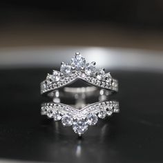 a diamond ring on top of a black surface