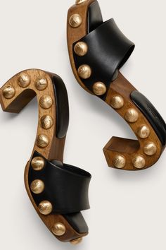 A sculptural mule designed with a curved wood frame, smooth leather straps and textured brushed brass studs. - Smooth nappa leather straps and sole - Moire textured brushed brass studs Luna Sandals, Unique Heels, Embroidered Flats, Clear Shoes, Luxury Designer Shoes, Curved Wood, Swimming Bag, Shoes On Sale, Many Shoes