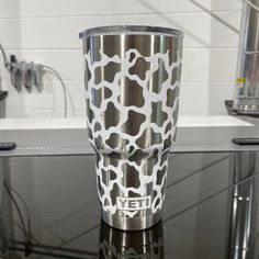 a stainless steel yeti cup with giraffe print on the lid and bottom