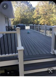 a deck with white railings and black hand rails