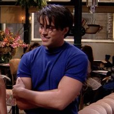 a man standing next to a woman in a living room on the set of friends