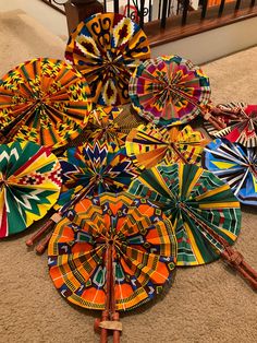 "Ankara Print Hand fan, made in Ghana. Fans are randomly selected unless otherwise specified. All fabrics are colorful Africa fabrics handmade into hand fan or Africa fan. Hand  fan fold with real leather handles wrapped around bamboo. Handmade fan that is foldable and fits inside your purse. This can also be used as an African inspired wall hanging decor. Foldable dimensions: about 12\" x 2.7\" Open dimensions: about 12\"  x 15\" Can be used as a practical statement piece fan on special occasions such as weddings, bridal shower, engagements, church service, parties or on a hot summer outing to any outdoor event.  It works also very well as a home decoration in a boho decor, patio decoration, she shed decor or in an African inspired home décor theme. Fabric is hand printed, on 100% cotton Africa Theme Party, Hand Fans Diy, Diy Dollar Tree Centerpieces, Dollar Tree Centerpieces, Fan Hand, African Theme, African Accessories, Gold Party Decorations, Ankara Print