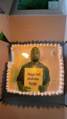 a birthday cake with a photo of a man holding a sign