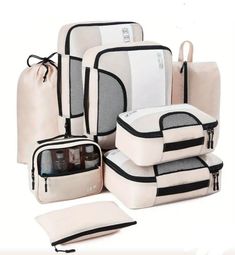 several pieces of white luggage with black trimmings and zippered pockets on each side