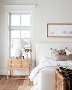 the instagram page shows an image of a bedroom with white walls and wood floors