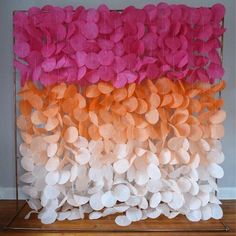 a group of pink, orange and white paper flowers