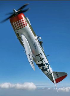 a red and white airplane flying through the sky