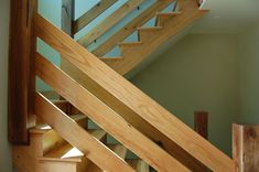 a wooden staircase in a house with green walls