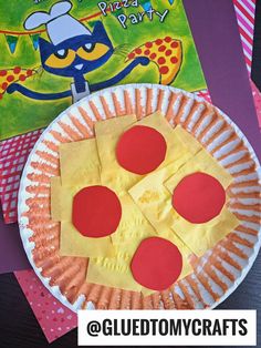 a paper plate with some pizza slices on it and a book in the back ground