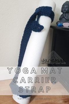 a white yoga mat sitting on top of a wooden floor next to a blue scarf