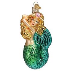 a glass ornament shaped like a mermaid holding a fish on it's back