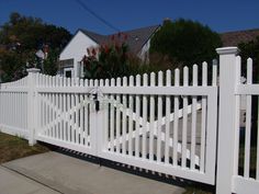 a white picket fence in front of a house