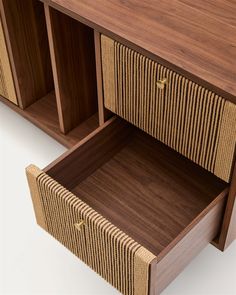 a close up of a wooden cabinet with two drawers and an open drawer on one side