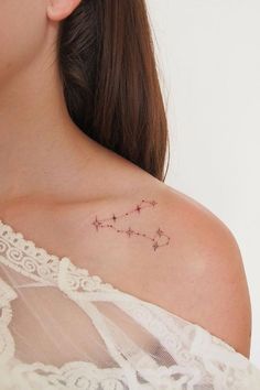 a woman with a small tattoo on her neck