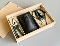 two pairs of scissors in a box with some leather material on the inside and outside