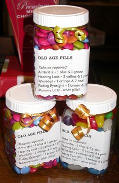 three jars filled with candy sitting on top of a table