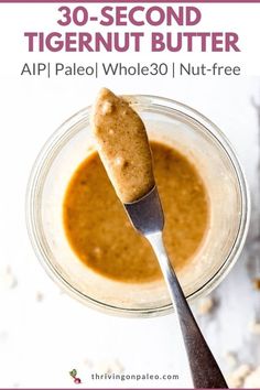 a close up of a spoon in a bowl with peanut butter on it and the words 30 - second tigernut butter