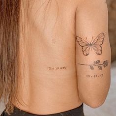 a woman with a butterfly tattoo on her back