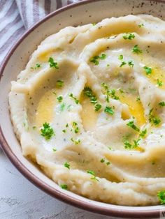 mashed potatoes topped with parsley in a bowl