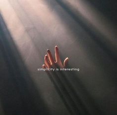 a person's hand reaching up into the air with sunlight streaming through them and texting simplily is interesting