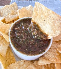 a white plate topped with chips and salsa