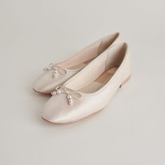 We added the most feminine gemstone to the most feminine ballet flat. In an ivory hue, CACY PEARL’s delicate bow is adorned with dainty pearls. This flat is ideal for the laid-back, comfort seeking bride, but she styles great with denim and floral dresses too. Textile Upper Recycled Synthetic Outsole Textile Lining Water-based Leather Alternative Sock 0.4" Heel Height Imported Hoco Shoes, Graduation Heels, Ingenue Essence, Church Shoes, Fairytale Wedding Theme, Wedding Shoe Ideas, Ivory Flats, White Ballet Flats, Pumps Outfit