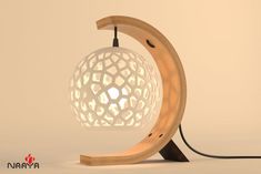 a wooden table lamp with a white ball on it's base and a black cord