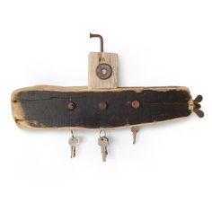 a piece of wood with keys hanging from it's side and a key holder attached to it