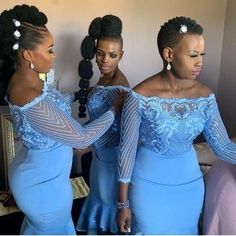 three women in blue dresses standing next to each other