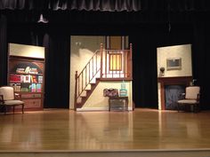 an empty stage with chairs and stairs