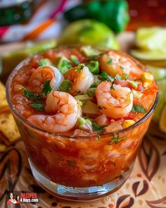 a glass dish filled with shrimp and garnish