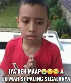 a young boy standing in front of a white truck with the words ampun bang on it