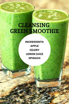 two glasses filled with green smoothie sitting on top of a counter