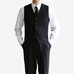 Introducing the Classic Fit Men's Basic Wool Blend Suit Vest in Black Color. This dress suit waistcoat is a stylish addition to elevate any gentleman's formal attire. Designed with a classic fit, this vest offers a timeless and sophisticated silhouette. The black color adds a touch of refinement, making it suitable for a variety of formal occasions and events. The 5-button design of this waistcoat adds a polished and traditional touch. It features a clean and minimalistic design, allowing it to effortlessly complement any dress shirt and suit combination. Whether you're attending a wedding, a business meeting, or any formal event, the Classic Fit Men's Basic Wool Blend Suit Vest in Black Color is the perfect choice to complete your formal ensemble. It exudes sophistication and adds a refin Classic Formal Vest With Button Closure, Formal Notch Lapel Vest With Buttons, Tailored Semi-formal Vest With Button Closure, Classic Workwear Vest With Buttons, Classic Business Casual Vest With Buttons, Business Three-piece Suit With Buttons, Tailored Vest With Button Closure For Semi-formal Occasion, Business Three-piece Suit In Suiting Fabric, Sleeveless Black Blazer For Business