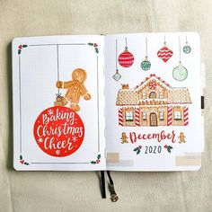 an open christmas planner with ornaments hanging from it's sides and a gingerbread house on the cover