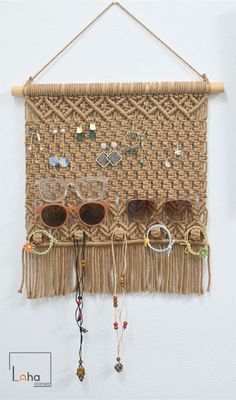 a woven wall hanging with sunglasses on it