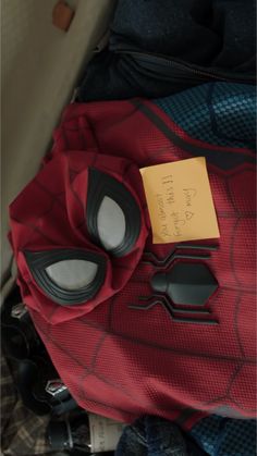 a spider - man costume and other items are sitting on the back of a car