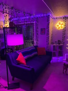 a living room filled with furniture and purple lighting