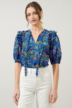 Maximal fun. Multi floral clusters work together to shape this breezy blouse. Oversized puff sleeves with ruffle trim along the shoulder frame a split neck and tie. The top maintains a relaxed fit, making it easy to style. Wear it tucked into your favorite pair of jeans, along with sandals and you're good to go!- TIe neck- Split neckline- Relaxed fit- Puff sleeves- Color: Cobalt ComboSize + Fit - Model is 5'8" and wearing size XS- Measurements taken from size S - Chest: 20 1/4"- Length: 25 1/2" Vibrant Blue Tops With Colorful Pattern, Vibrant Blue Top With Colorful Pattern, Chic Blue Blouse With Vibrant Print, Jeans Top Outfit, Playful Multicolor Printed Blouse, Chic Printed Tie Neck Blouse, Top And Jeans Outfit, Jean Top Outfits, Blouse Outfit Casual