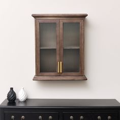 a black cabinet with two glass doors on it