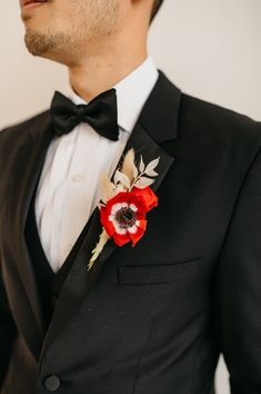 a man in a tuxedo with a boutonniere on his lapel